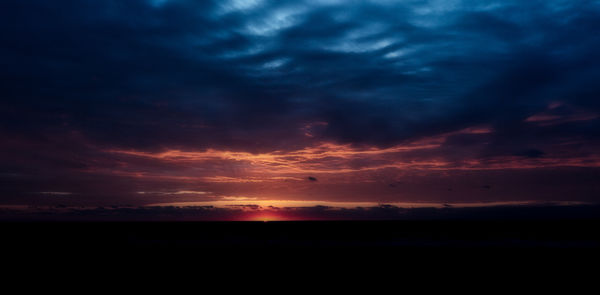 Silhouette of sea against sky at sunset