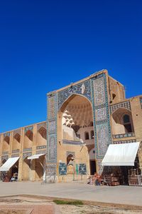 Low angle view of temple against clear blue sky