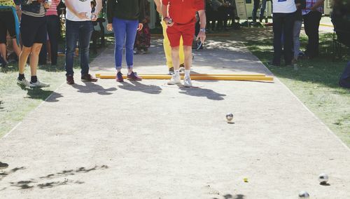 Low section of people playing boules at park