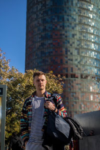 Portrait of man standing in city