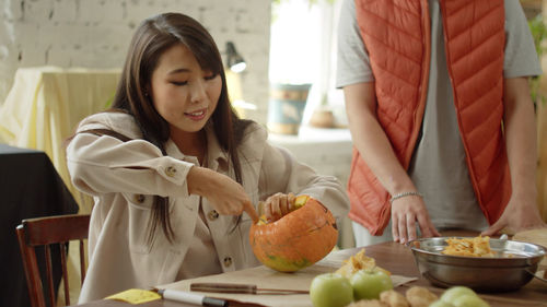 Portrait of young woman holding food