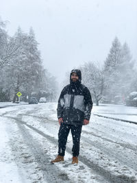 Full length of man standing on snow covered field