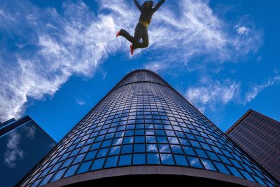 Low angle view of office building against blue sky