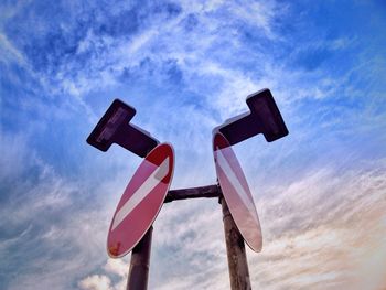 Low angle view of road sign against sky