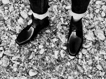 Low section of person standing on stones