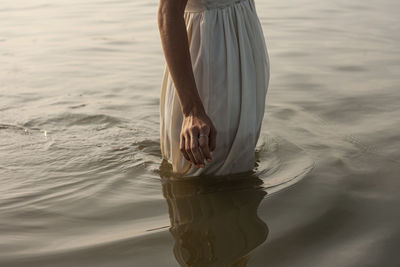 Low section of woman standing on beach