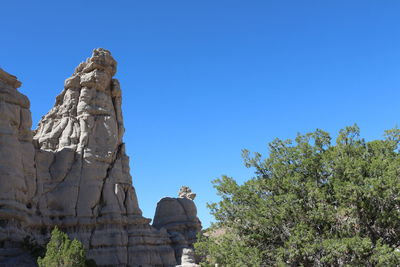 Low angle view of statue against clear blue sky