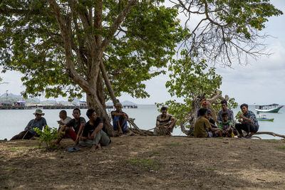 Group of people sitting on the ground