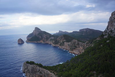 View of calm sea against mountain range