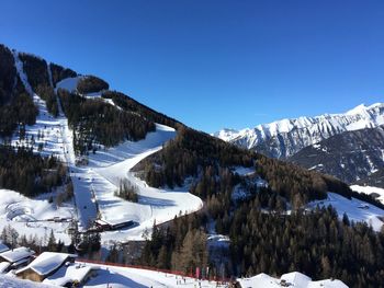 Scenic view of snow covered mountains against clear sky