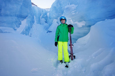 Rear view of man skiing on snow covered mountain