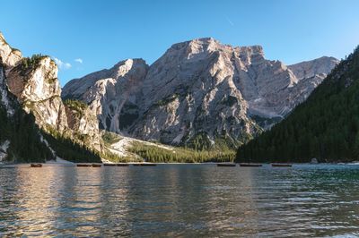 Scenic view of lake and mountains against clear sky