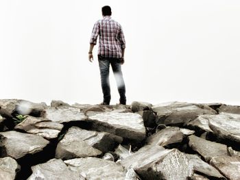 Full length of woman standing on rock