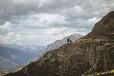 Scenic view of mountains against cloudy sky