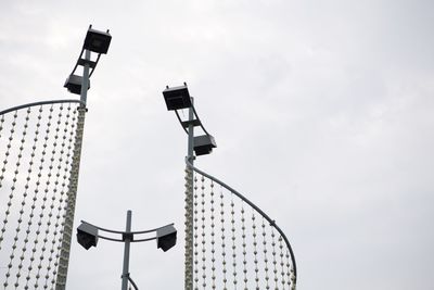Low angle view of communications tower against sky