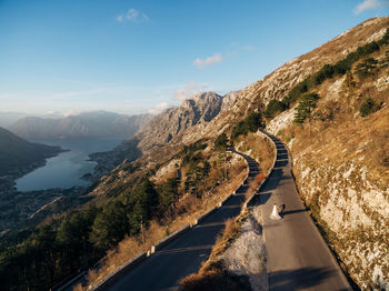 Road amidst mountains against sky