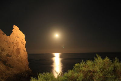 Scenic view of sea against sky at night