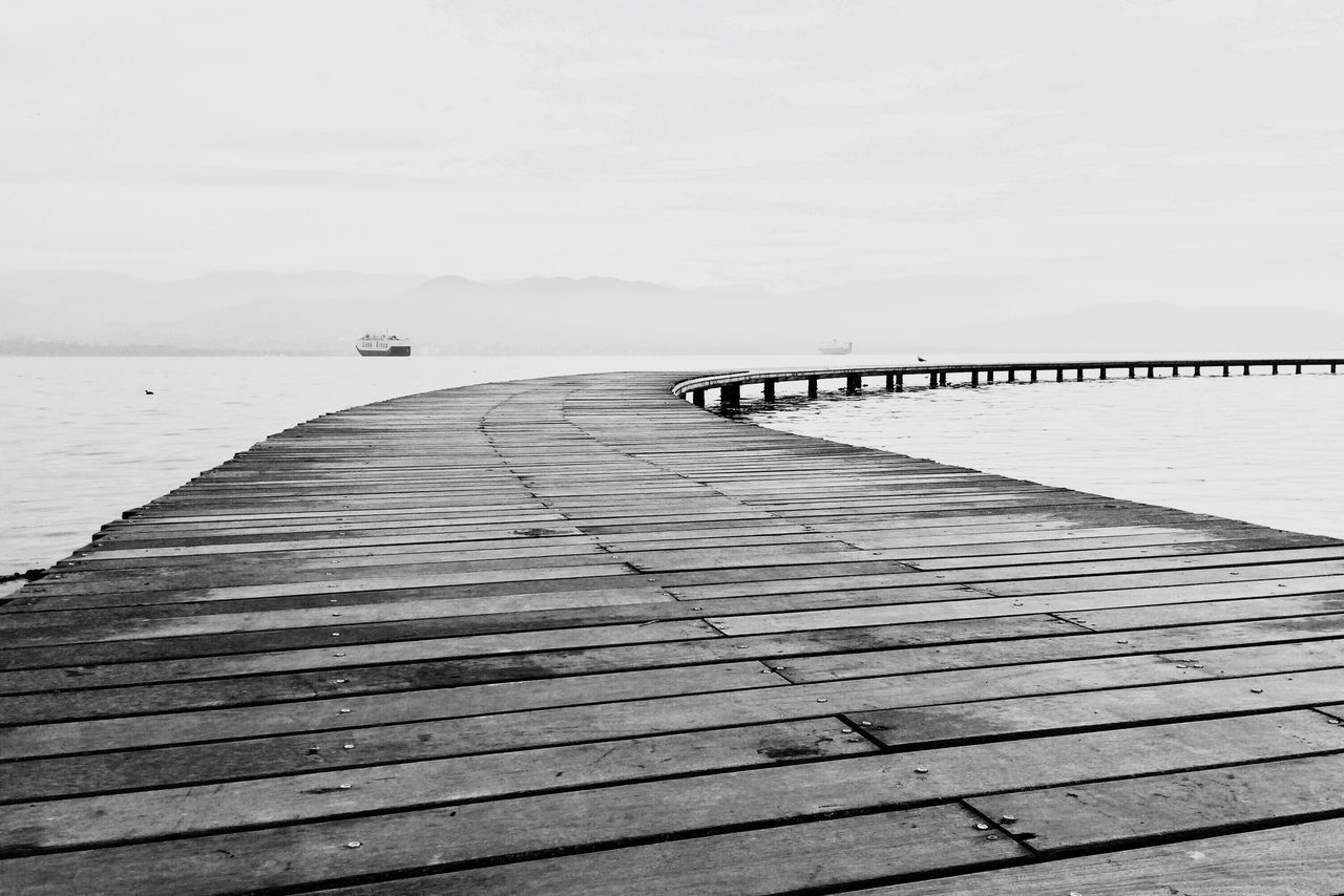 sea, water, pier, the way forward, railing, horizon over water, boardwalk, tranquility, tranquil scene, wood - material, jetty, sky, scenics, clear sky, diminishing perspective, nature, built structure, copy space, long, beach