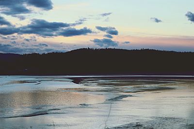 Scenic view of lake against sky during sunset