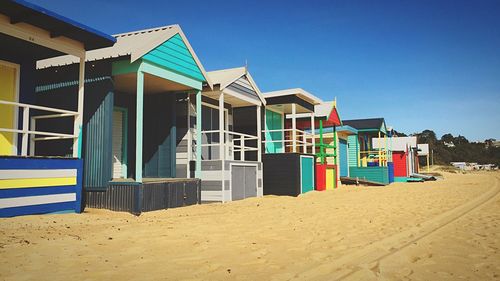 Built structure on sand against blue sky