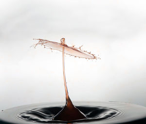 Close-up of liquid splashing against white background