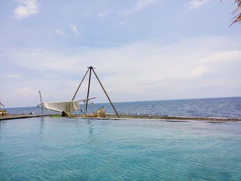 Sailboat in swimming pool against sky