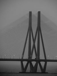 Low angle view of suspension bridge against sky