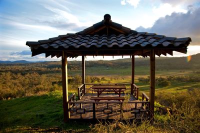 Gazebo on field against sky