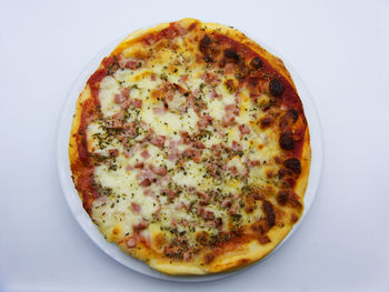 High angle view of pizza in plate against white background