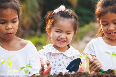 Portrait of happy girl holding girls