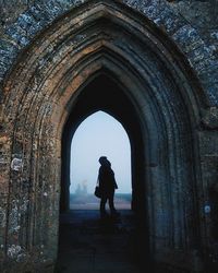 Full length of woman walking in tunnel