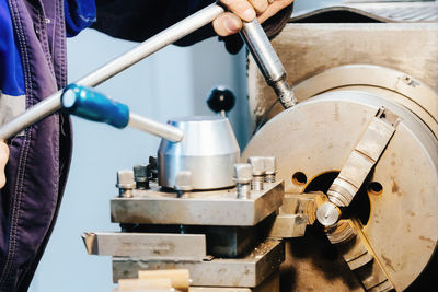 Turner hands and lathe close-up. metal turner works at workplace in lathe shop. industrial