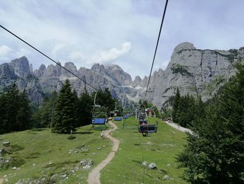 Ski lift over mountains against sky