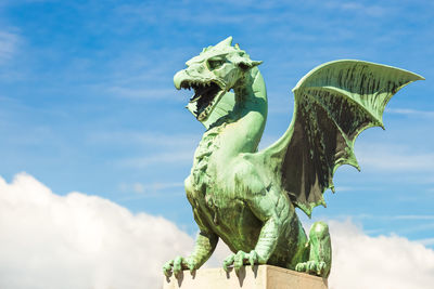 Close-up of statue against blue sky