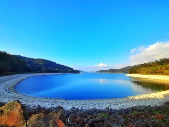 Scenic view of lake against blue sky