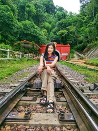 Full length of woman on railroad tracks