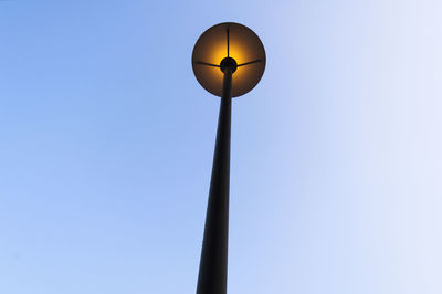 Low angle view of wind turbine against clear sky