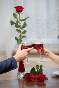 Midsection of woman holding wineglass