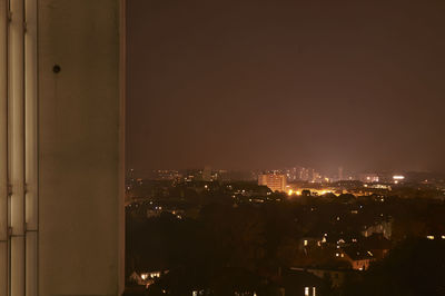 Illuminated cityscape against sky at night