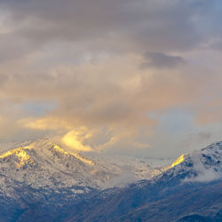 Scenic view of snowcapped mountains against sky during winter