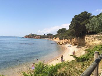 Scenic view of beach against clear blue sky