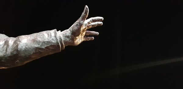 Close-up of hand against black background