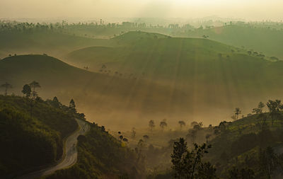 Scenic view of landscape against sky during foggy weather