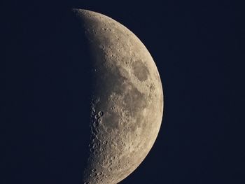 Low angle view of half moon against sky at night