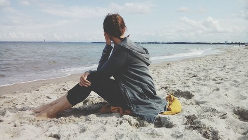 Woman on beach against sky