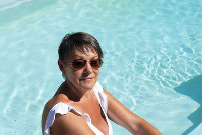 High angle view of smiling senior woman in swimming pool