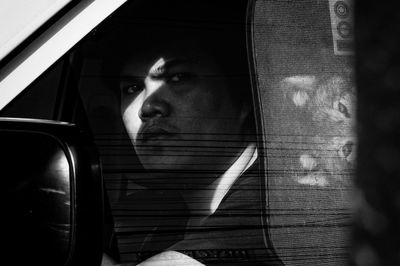 Portrait of man seen through glass window