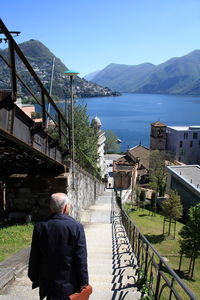 Rear view of senior man moving down on steps