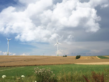 Windmill on field against sky