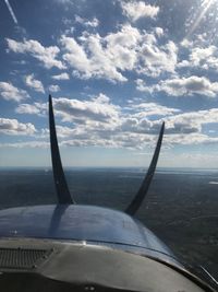 Close-up of airplane wing over sea against sky